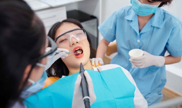 dentist-drilling-teeth-young-female-patient-suffering-from-teethache