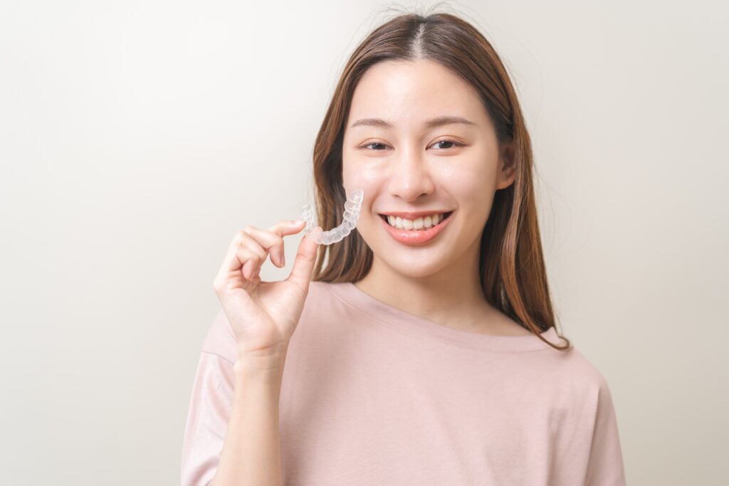 Patient holding her invisible braces
