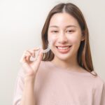 Patient holding her invisible braces