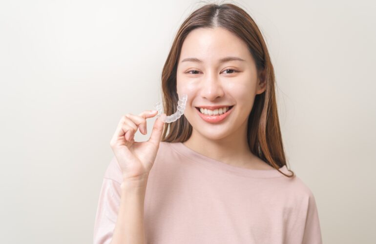 Patient holding her invisible braces