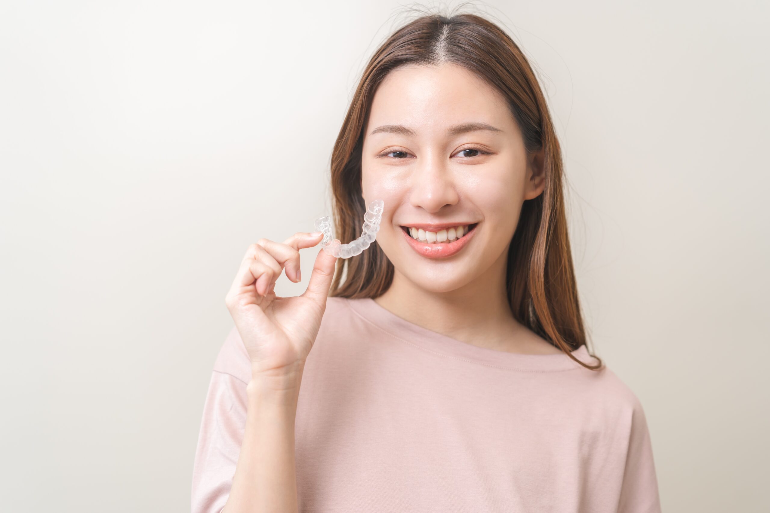 Patient holding her invisible braces