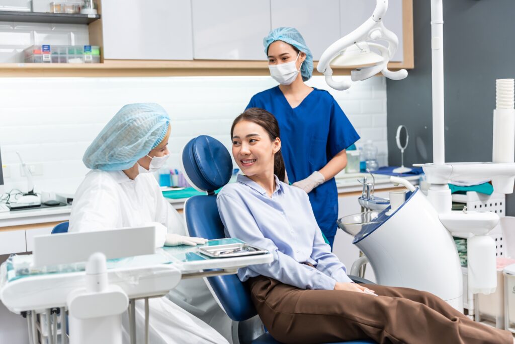 a dentist with her assistant discussing the dental crown procedure in Singapore