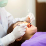 an image of a dentist doing a dental extraction on a patient