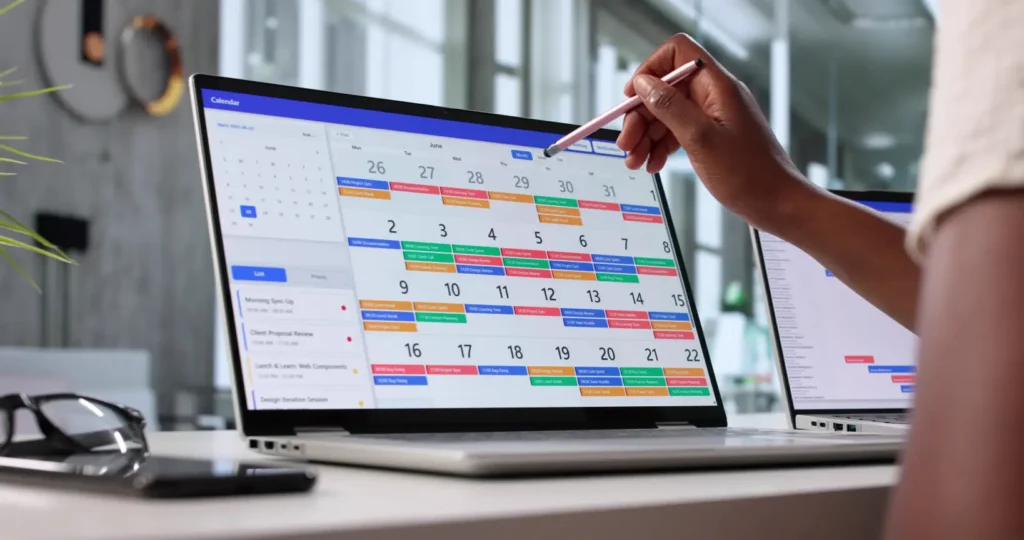 A remote worker scheduling a day off in his calendar from his laptop