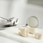 Removed wisdom teeth on a tissue next to dental appliances. This indicates a dental extraction