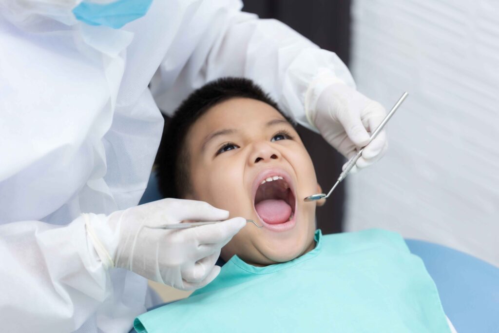 a young boy undergoing paediatric dentistry at a bukit timah dental clinic