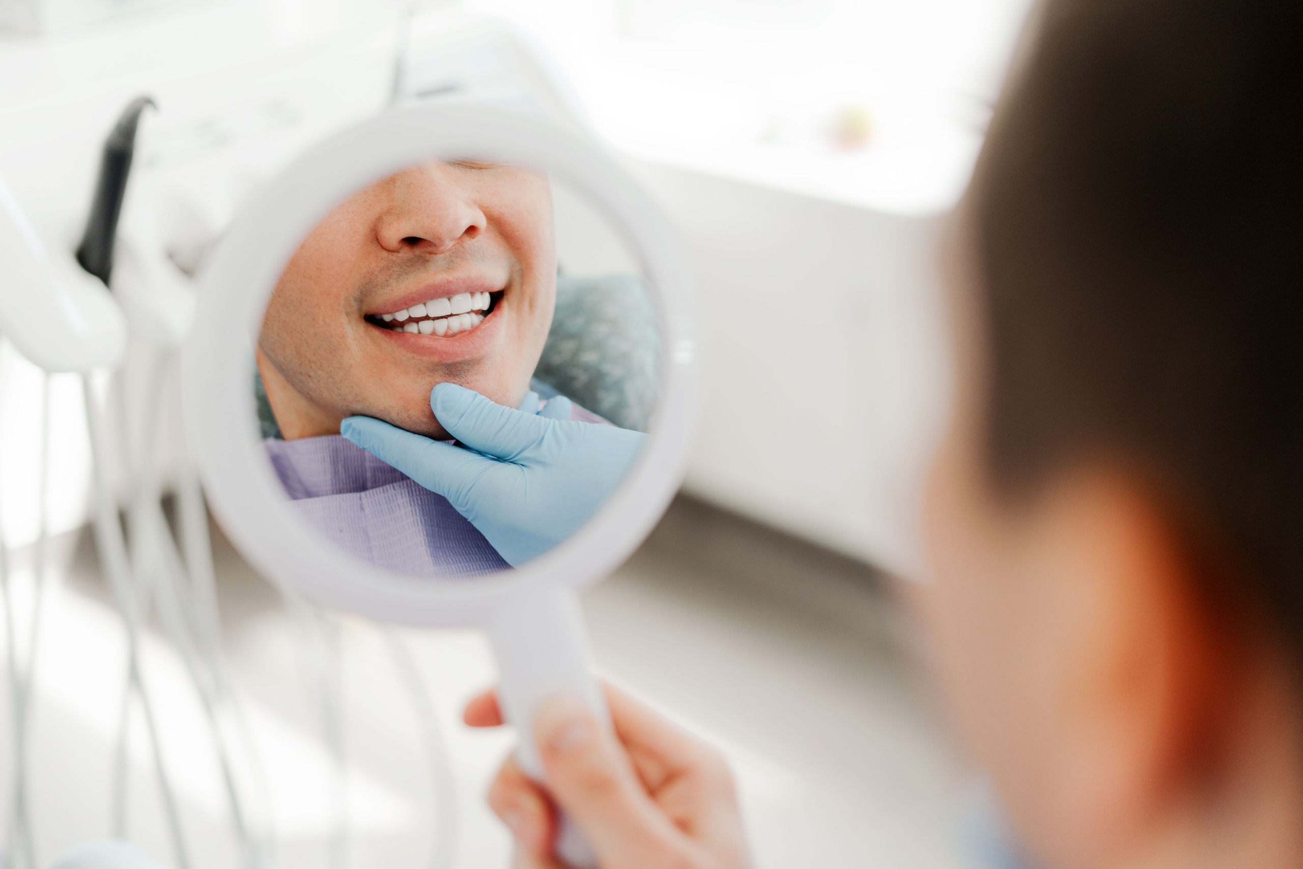 A happy man looking at his teeth with better smile design